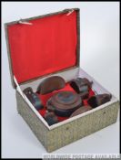 A cased mid century Chinese tea service for four, to include a KangXi teapot, four cups and saucers.