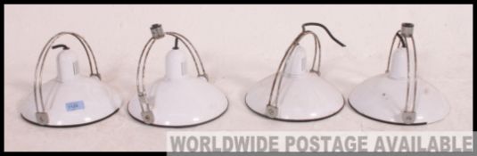 A set of 4 1970's retro enamel and chrome pendant lamp shades.