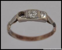 A yellow metal ring with a 10pt and a 5pt diamond. Size N. Weight 1.6g.