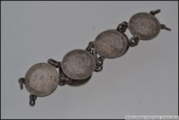 A vintage white metal three pence link bracelet with coins dating from 1932 to 1940 with hook clasp.