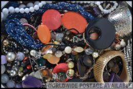 One large tin of assorted costume jewellery.