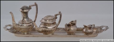 A silver hallmarked miniature tea service on rectangular tray comprising teapot, coffee pot,