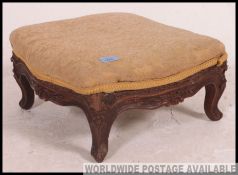 A stunning 19th century mahogany carved rococo footstool of square form raised on carved legs and