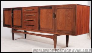 A good retro 1970's long and low G plan Fresco teak sideboard enclosed by moulded panelled door