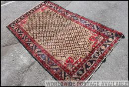 An early 20th century handwoven Islamic / Persian Isfahan rug having an unusual beige centre with