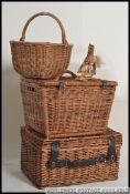 A collection of whicker hampers and baskets from the 20th century together with a wooden miniature