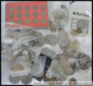 A large box of mixed coins of varying ages.