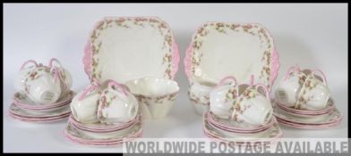 An early 20th century Shelley part tea service in a chintz floral pattern to include cups, saucers,