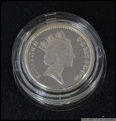 A silver One Pound Proof Coin complete in the box with certificate 1986.