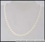 A ladies pearl necklace choker with 18ct gold clasp. Total weight 24.