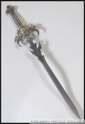 A Medieval style replica steel bladed broad sword with white metal scorpion detailing to the cross