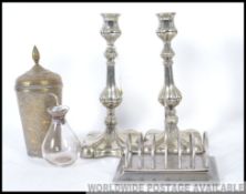 2 good quality silver plate candlesticks together with a silver and glass oil bottle and a toast
