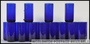A collection of 20th century Bristol blue style glass beakers / tumblers still in the original