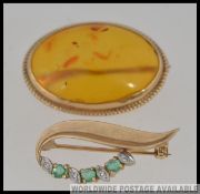 A ladies 9ct gold diamond and emerald ladies brooch of leaf form together with a 9ct gold and amber