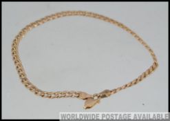 A 9ct gold curb link bracelet with lobster claw clasp. Weight 2.6g. Measures 10cms.