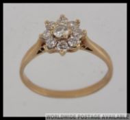 A 9ct gold daisy ring with diamond encrusted flower head approx 50pnts. Total weight 1.