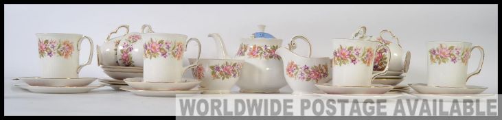 A Colcough vintage chintz pattern part tea service together with a matching pattern service