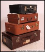 A vintage 20th century stack of vintage suitcases to include varying sizes, colours etc,