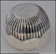 A solid silver heavy ribbed hallmarked silver bowl. Marks rubbed to underside (unreadable).
