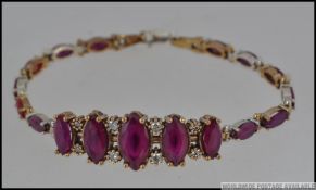 A silver metal CZ and rubilite set bracelet