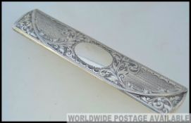 A Victorian silver hallmarked crochet hook case in the form of a spectacle case engraved with