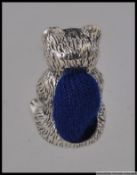 A silver white metal pincushion in the form of a cat / bear H2cm