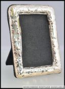 An Edwardian style white metal 925 silver easel backed photograph frame.
