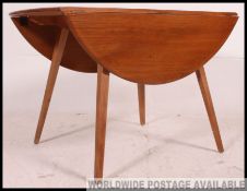 Retro / Vintage 1960's circular drop leaf Golden Dawn dining table by Ercol. Measures: 73 x 113.