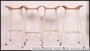 A set of 4 retro mid century rattan weave metal bar stools.