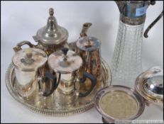 A collection of silver plated items to include part tea service, salver, muffin warmer,