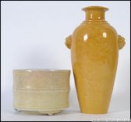 A Chinese monochrome yellow vase adorned with fu-dog masks and incised decoration of dragons and