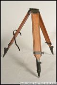 A good mid century wooden and enamelled metal tripod stand of chunky heavy construction ideal as a