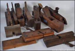 A collection of assorted vintage wooden carpenters planes,
