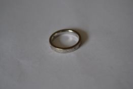 A designer hallmarked Birmingham 18ct white gold band ring set with 8pts diamonds Weight 3.9g.