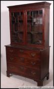 An 18th century Georgian mahogany bookcase on chest of drawers.