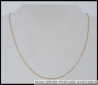 A 9ct gold rope chain with spring hoop clasp. Marked 9ct.