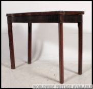 A 19th century mahogany serpentine fronted games / card / tea table raised on squared legs with