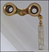 A pair of 20th century brass and mother of pearl opera glasses W11cm