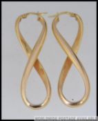 A pair of large Italian designer hallmarked 9ct gold earrings with twisted hoop design and post