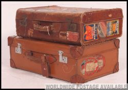 A near pair of vintage leather suitcases,