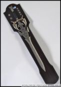 A Medieval style replica steel bladed broad sword with white metal snake and skull detailing to the