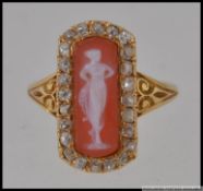 An unmarked Italian gold ring tests for 18ct with central cameo of an ethereal maiden with a halo