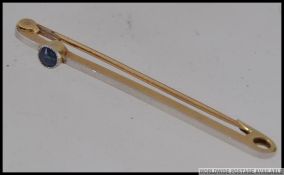 A 15ct gold bar brooch .