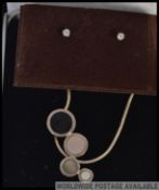 A good pair of ladies 9ct white gold and diamond stud earrings presented on a baize pad together