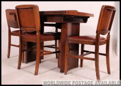 A mid 20th century Art Deco oak draw leaf refectory style dining table raised on turned legs