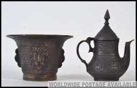 Two 20th century bronze items - a small cast teapot and a similar bronze bowl dish.
