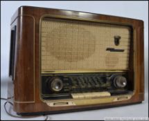 A vintage 1940's / 1950's Grundig 3D valve radio with decorative facia inset a walnut case