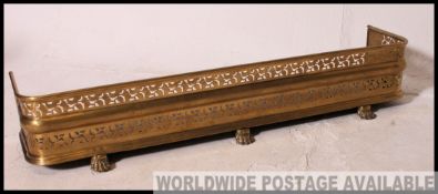 A good Victorian brass fire fender kerb having ribbed top with pierced central design.