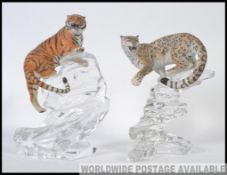 A Franklin mint collectors pair of wildlife figures to include a crouching Leopard and Tiger both