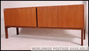 A stunning 1960's Gordon Russell sideboard of long and low form raissed on squared supports with